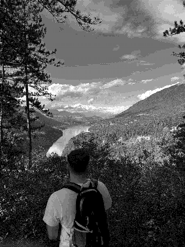 Elias from behind, looking at a mountain valley