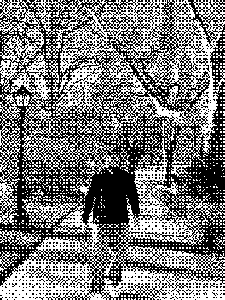 Elias walking down a tree-lined park alley